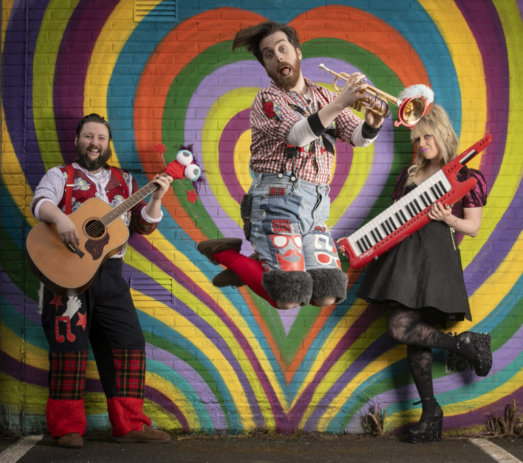 MUSICIANS DRESSED IN COLOURFUL CLOTHES FOR EASTSIDE ARTS FESTIVAL